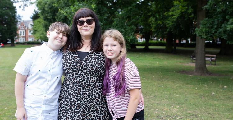 A mother with her son and daughter in a park A mother with her son and daughter in a park