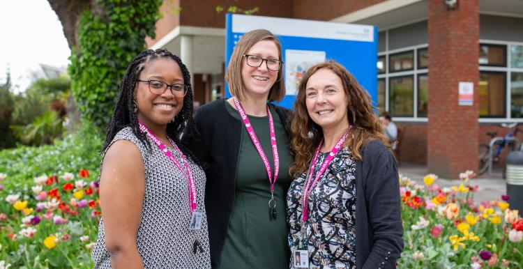 Three Healthwatch staff members standing outside a hospital Three Healthwatch staff members standing outside a hospital