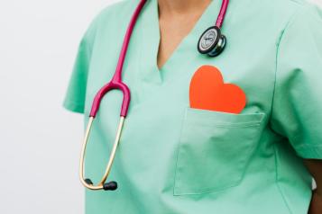 A healthcare professional with a stethoscope and red heart symbol 