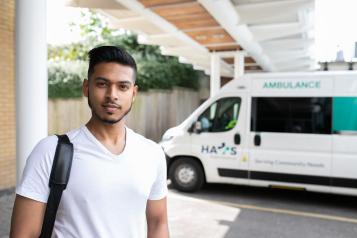 young man standing near a ambulance