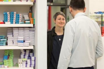 Person speaking to a pharmacist